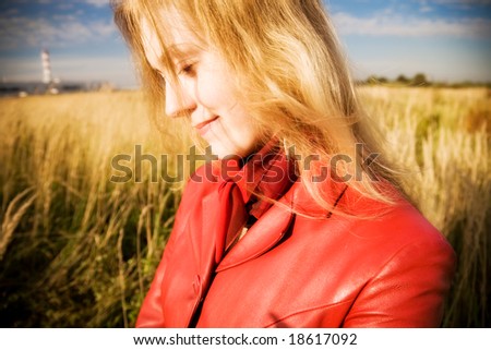 Young woman portrait on field background. Wide angle view.