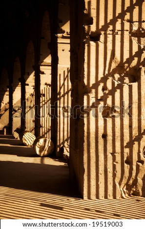 Latticed shadows concept. Shadows on antique columns in Coliseum.
