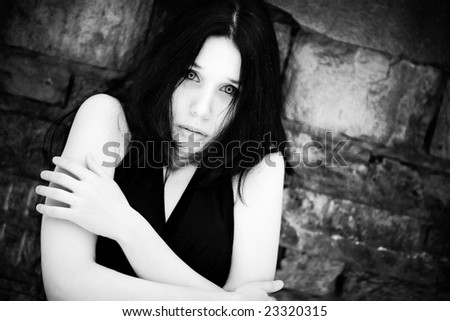 Young scared woman portrait. Black and white concept.