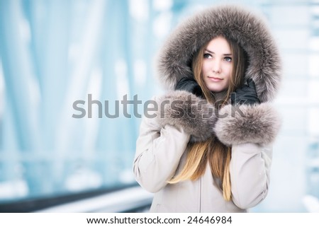 Young woman winter portrait. On abstract tech background.