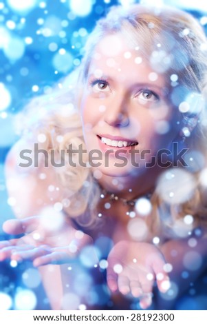 Young romantic woman catching falling flakes.