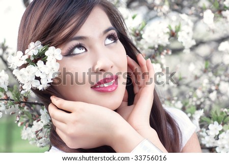 Young woman with cherry flowers. Bright white colors.