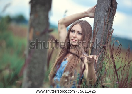 Young woman in a summer field calm portrait. Soft colors.