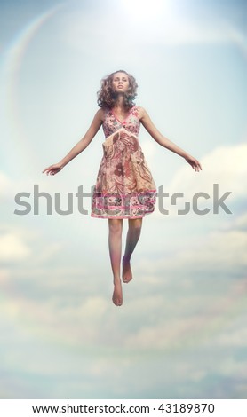Young woman flying up. Soft colors.