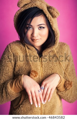 Young japan woman in bear suit. Sweet portrait.