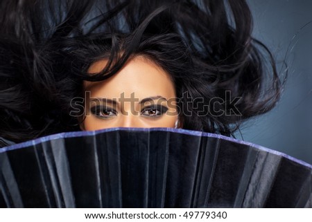 Young brunette woman stranger with fluttering hair.