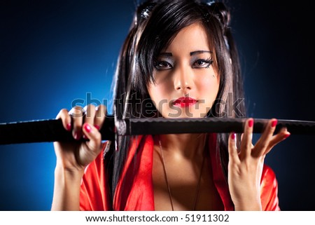 stock photo Young japanese woman with samurai sword fashion