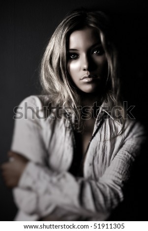Young woman portrait. Dark contrast colors.