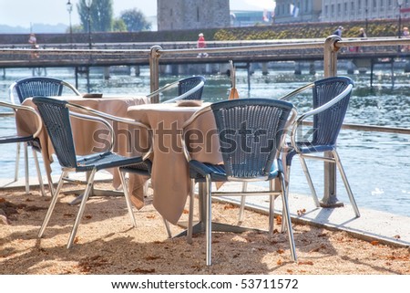 Cafe tables on river quay.