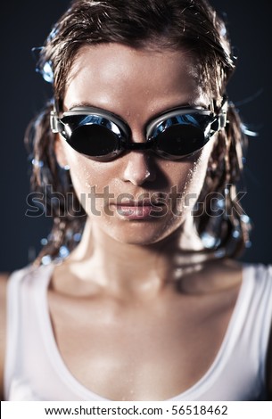 Young woman swimmer portrait. Water studio photo.