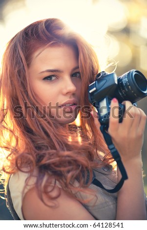 Young woman photographer. Soft colors and shallow doff.
