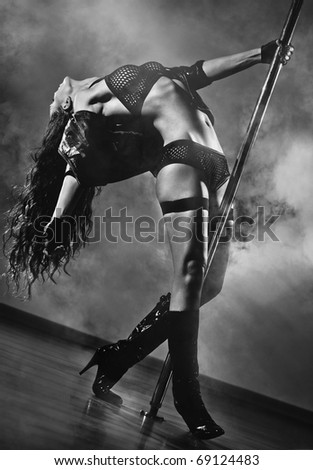 Young sexy pole dance woman. Black and white colors.