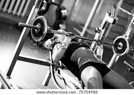 Young woman weight training. Black and white colors.