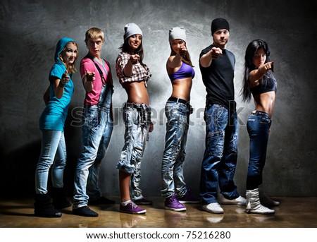 stock photo : Dancer team pointing. Contrast colors.