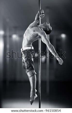 Young strong pole dance man.