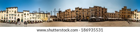 LUCCA, ITALY - AUGUST 18: Piazza dell\'Anfiteatro, one of main city attraction was built on the ruins of the ancient Roman amphitheatre, on August 18, 2013 in Lucca, Italy
