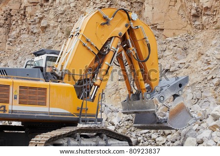 Excavator loading the crushed stone in quarry