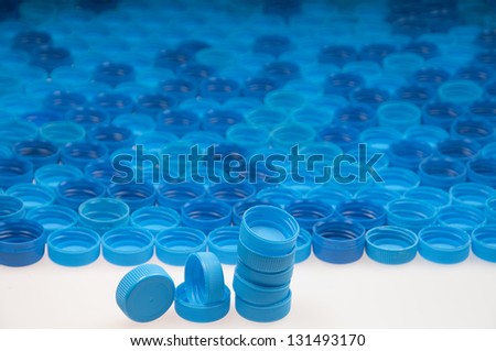 Blue plastic bottle caps in a row