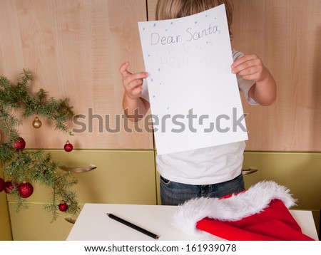 Blond boy writes a letter to Santa