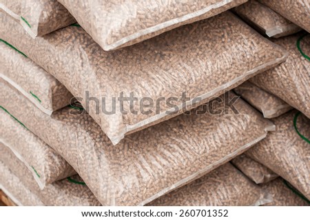 Pile of sacks of pellets, which are stacked on pallets