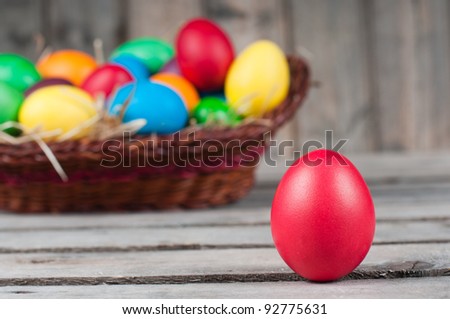 Easter eggs in  brown pannier - one egg is out, selective focus on a red egg