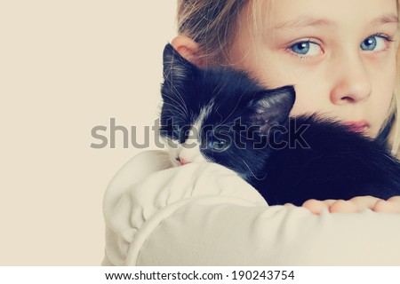 girl hugging kitten