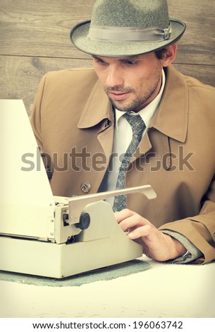 stylish man typing on a typewriter
