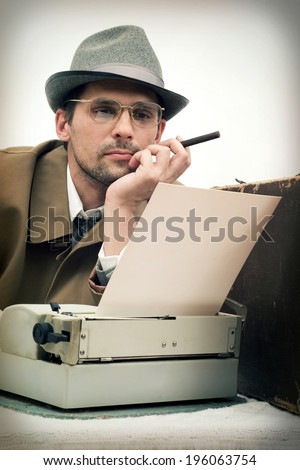 man typing on a typewriter