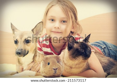 child and a cat and a dog and guinea pig