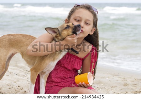 Child and puppy on the beach