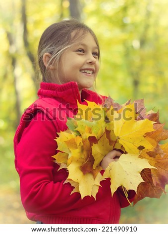girl and a bouquet of autumn leaves