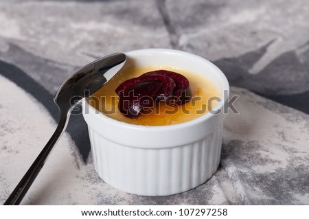 creme brulee with fresh slice cherries on top