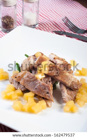 sliced pork steak with french beans and apple diced sauce
