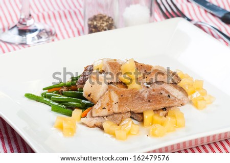sliced pork steak with french beans and apple diced sauce