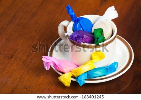 colorful wrapped polvoron/milk candies on a cup