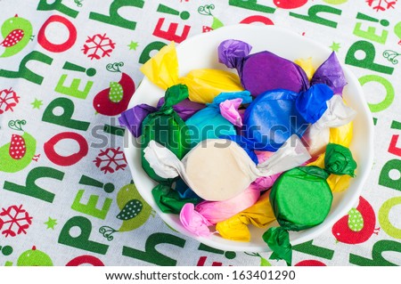 colorful wrapped polvoron/milk candies on a white bowl
