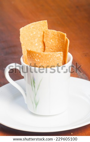 peanut brittle on a cup
