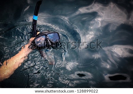 diving goggles and snorkel on hand