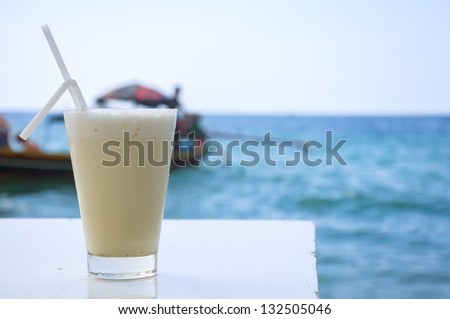 white cocktail on sea background