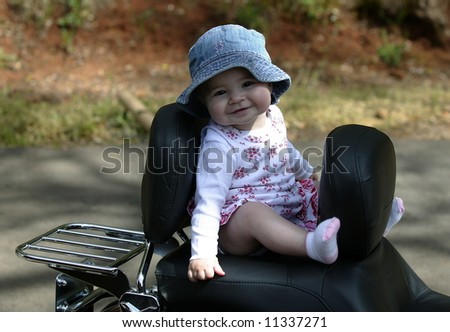 Eight month old baby girl on motorcycle