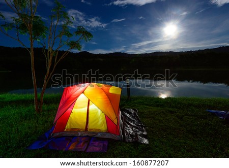 Illuminated Yellow Red Camping tent at Night