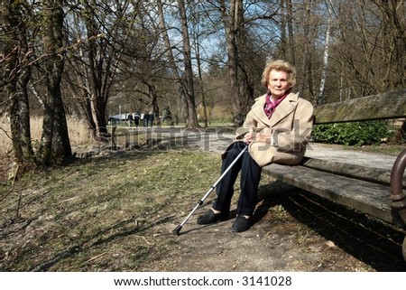 Granny Enjoying Sun! An elderly woman is enjoying the first sunrays in a park!