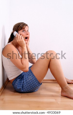 Shocking news A young woman is chatting on the phone in her apartment!