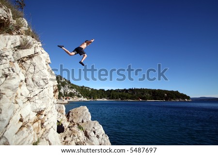 Taking A Risk A young man jumps from a cliff into the sea!