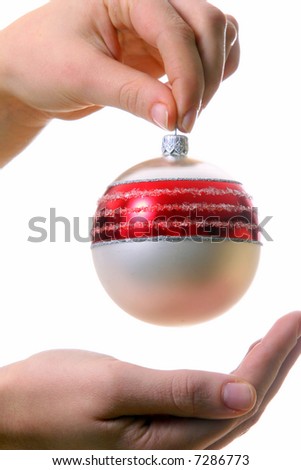 Christmas Around The Corner A young woman holds a christmas glitter ball. Isolated over white with a lot of space for text!