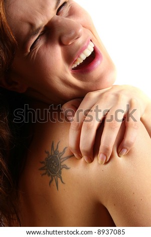 What A Pain! An isolated studio shot of a young woman with pain in her shoulder and neck.