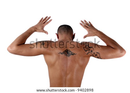 stock photo Masculine Young man showing his muscles and his tattooed back