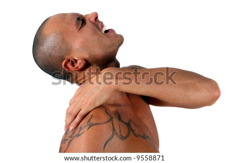 stock photo Tattoo And Pain A young man holds his shoulder in severe pain
