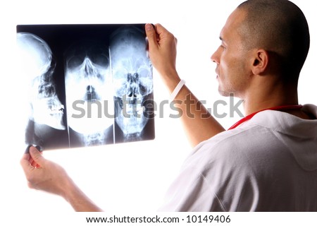 X-rays A young and handsome doctor check x-rays of a skull. A high-key shot!