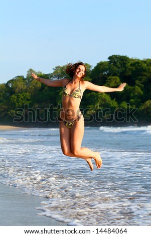 Jumping Beauty Young beautiful woman at the beach enjoying the sun and jumping for joy. Ideal summer / vacation shot.